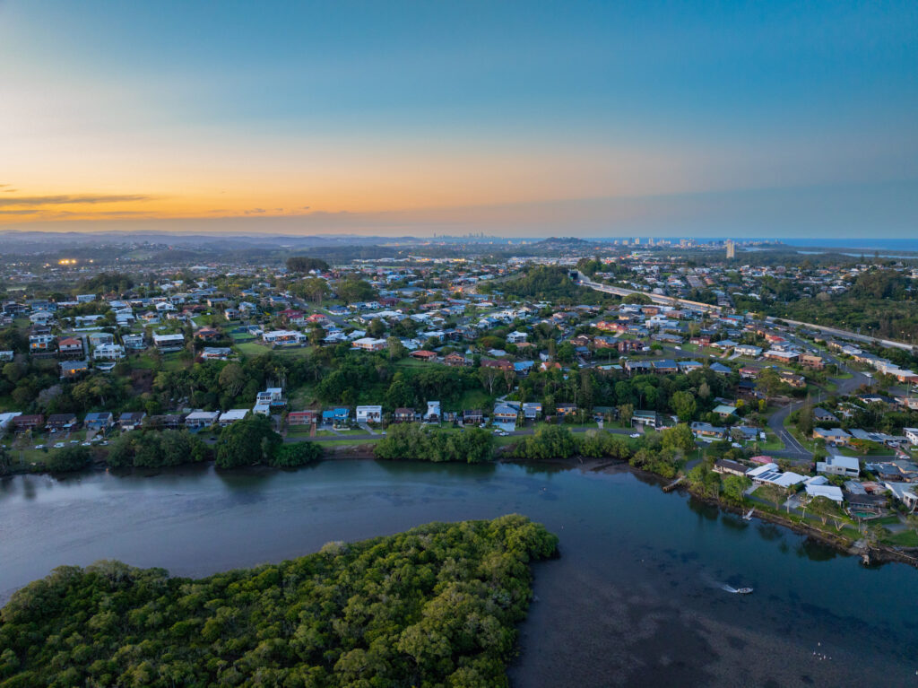 Elevated aerial sunset views of a residential area of east Banora Point, New South Wales, Australia