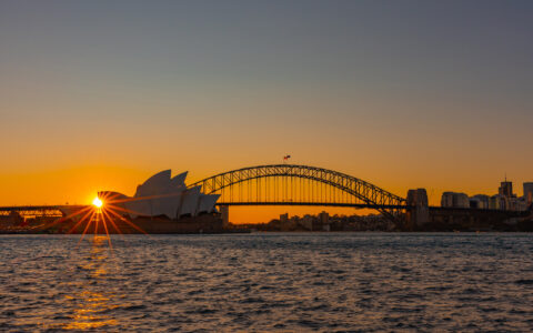 Star burst over Sydney Opera House at sunset viewed from Fleet steps near the Sydney Royal Botanic Garden