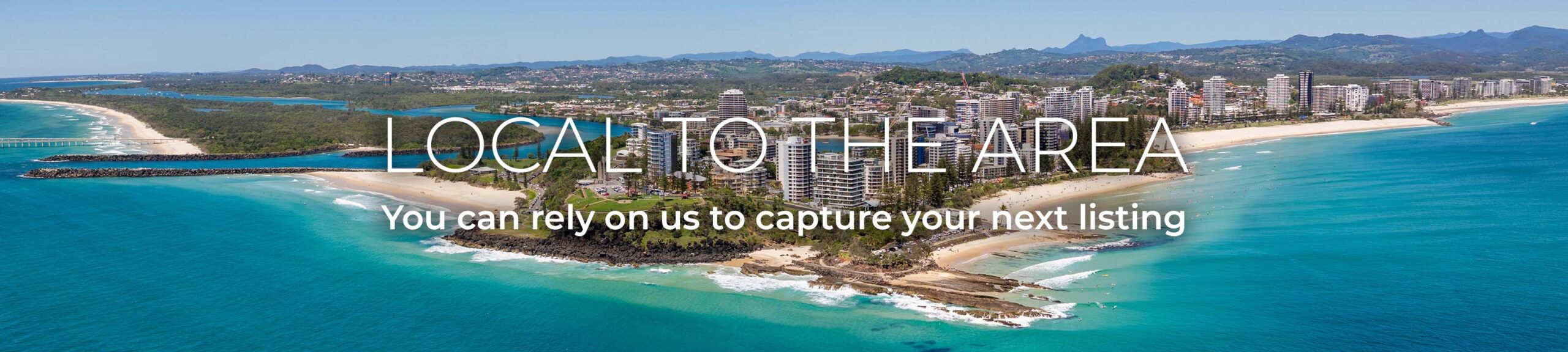 Aerial views of the Tweed Heads and Coolangatta coastline and skyline with Snapper Rocks and Rainbow Bay in the foreground and Fingal Head and Mount Warning in the background